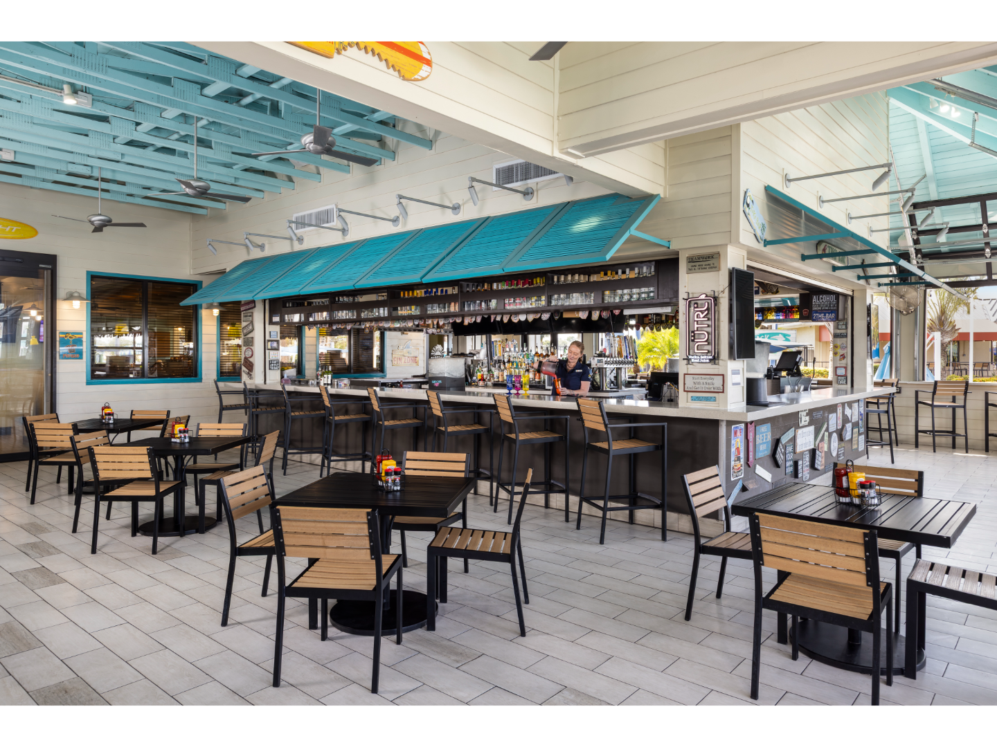 Casual indoor-outdoor dining area at a resort restaurant.