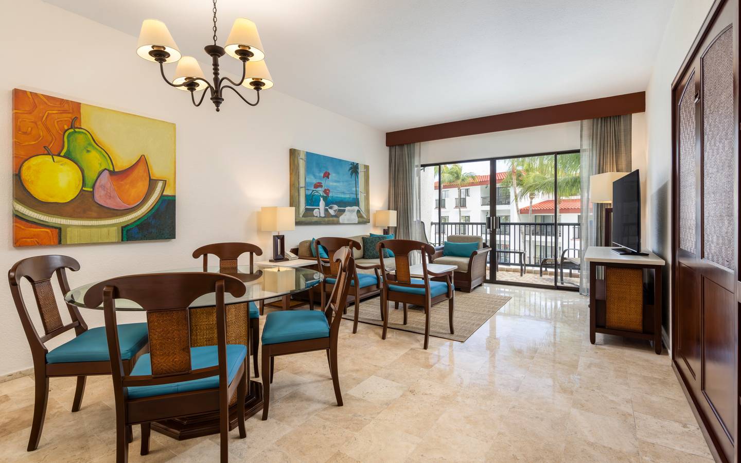 Two-bedroom Cancun suite with balcony and inviting living room.