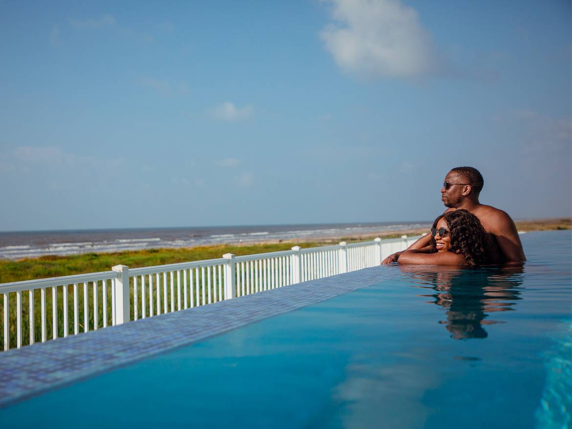 Couple in signature collection infinity pool at Galveston Seaside Resort