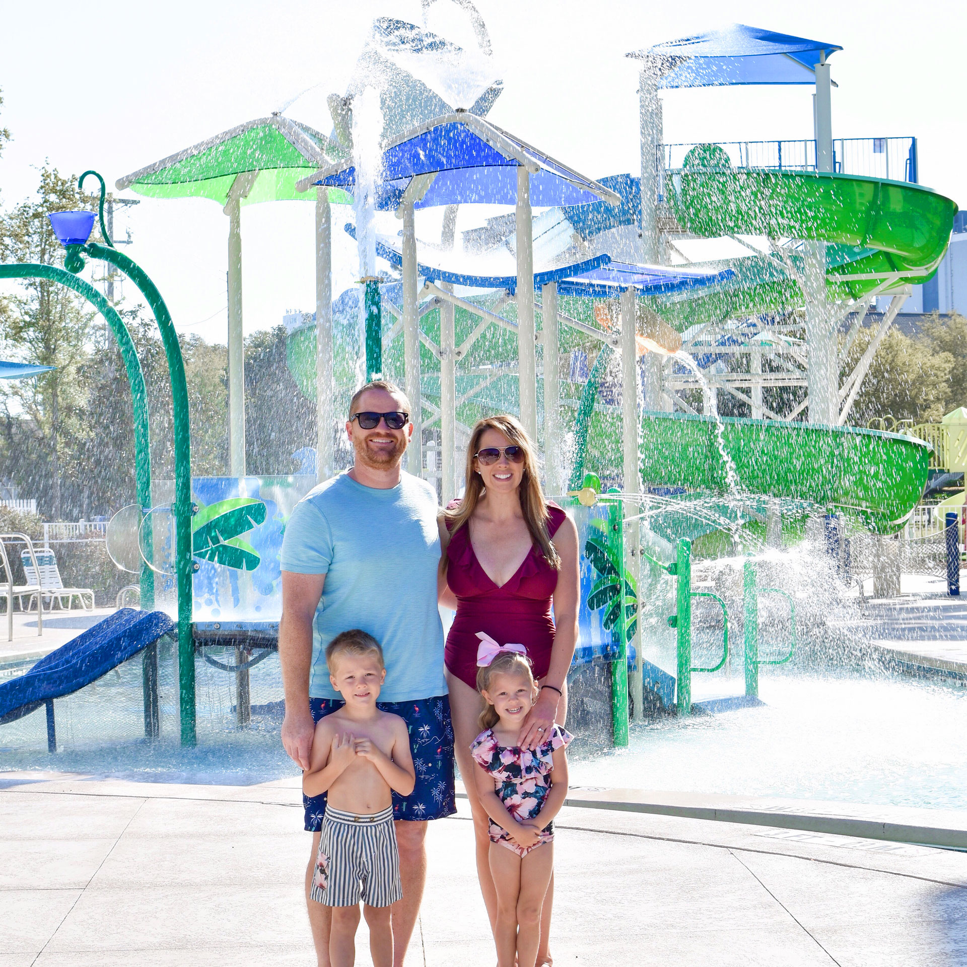 Featured Contributor, Brianna Steele (top right) stands with her family near the splash pad of our South Beach resort in Myrtle Beach, SC.