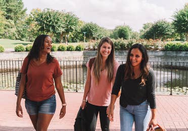 Three women checking into resort.