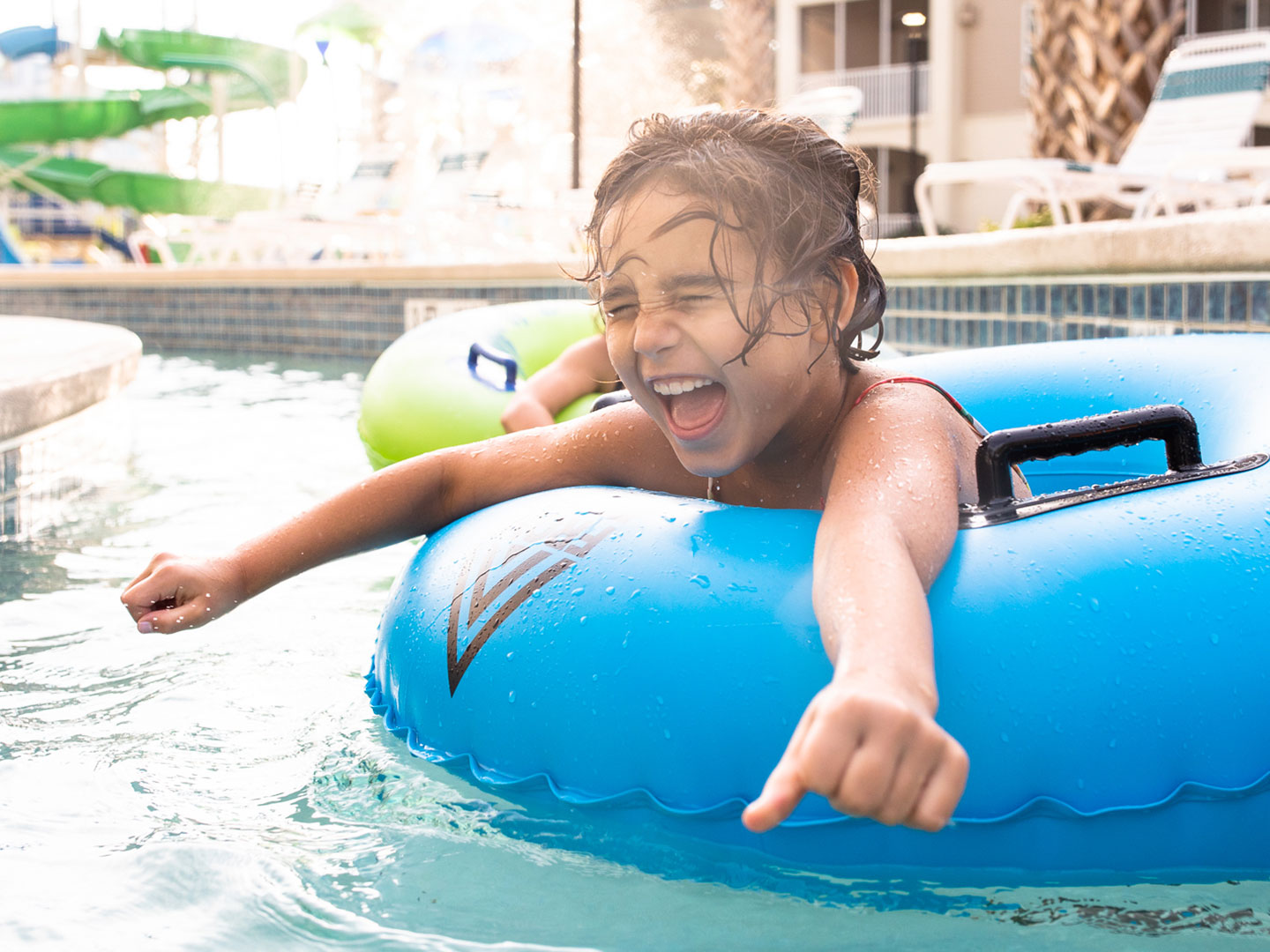 Author, Brenda Rivera Stearns' daughter, Victoria, floating along the lazy river in a blue innertube at our South Beach resort in Myrtle Beach, South Carolina.