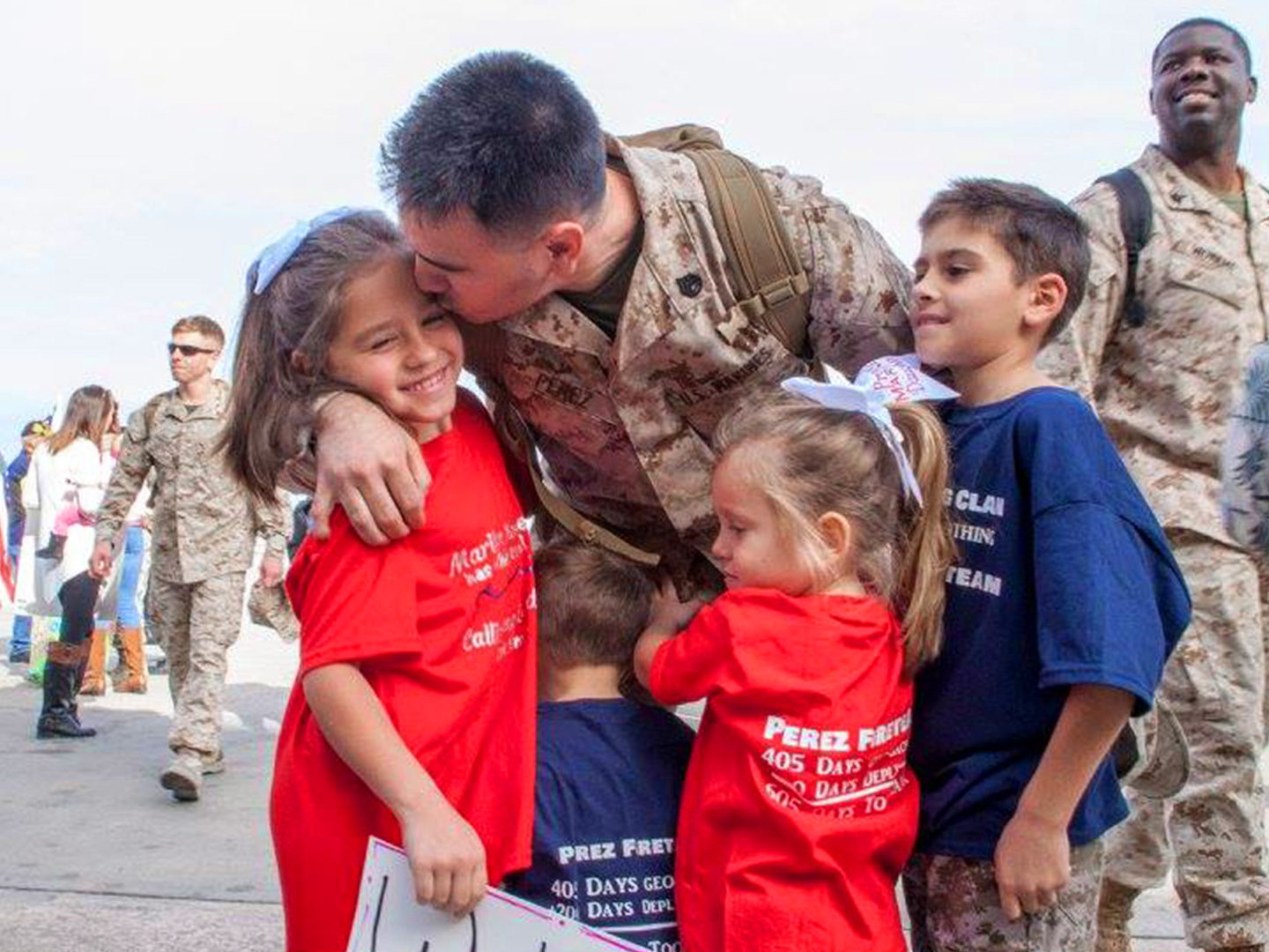 Sara Perezes husband wears his Army uniform as he kisses his daughter at his homecoming from his last deployment.