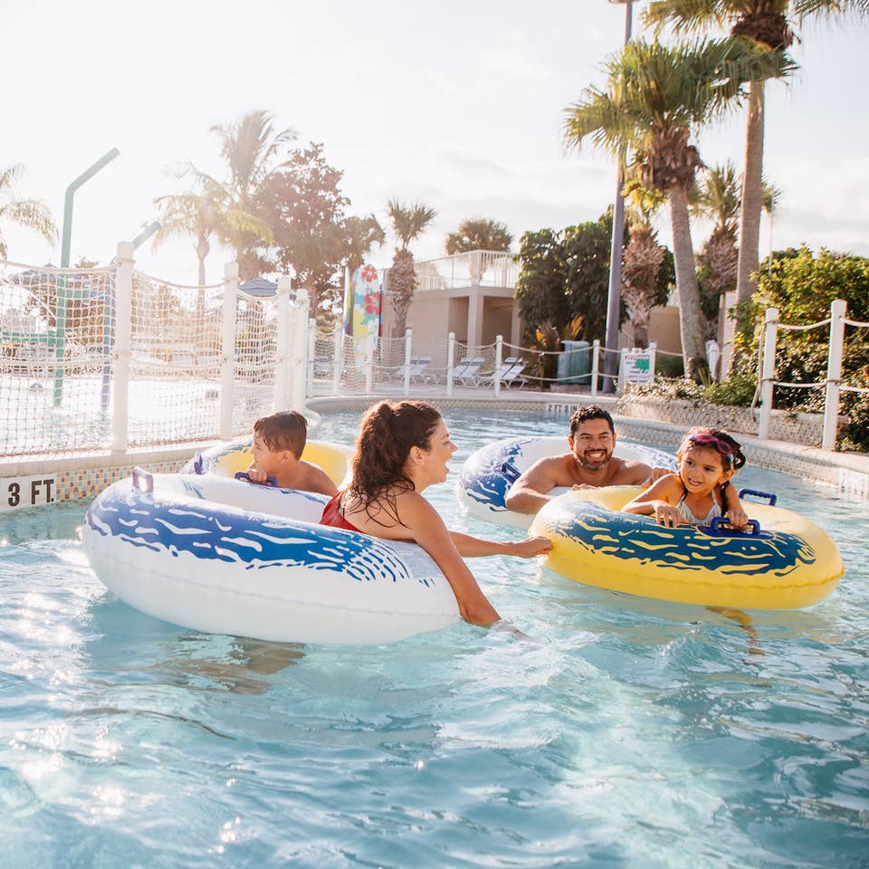 Family of four floating down lazy river at Cape Canaveral Beach Resort in Florida.