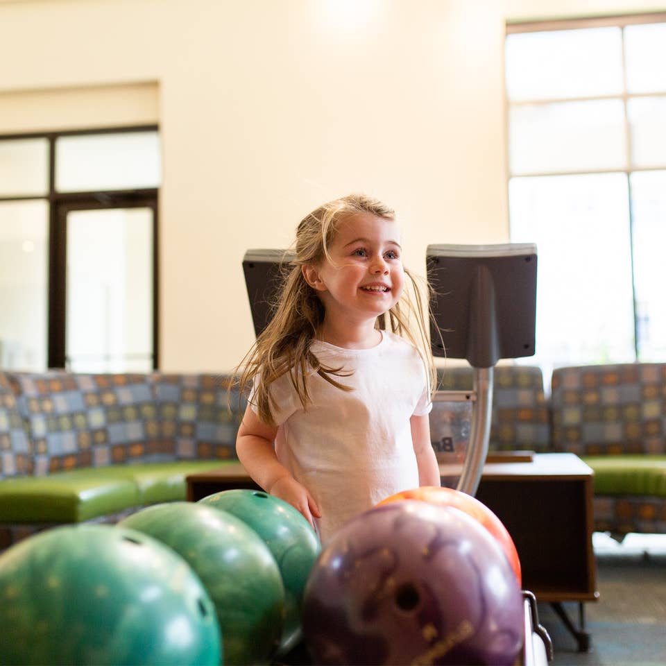 Young child bowling at Williamsburg Resort.