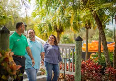 A couple walking with a salesman at River Island at Orange Lake Resort in Florida