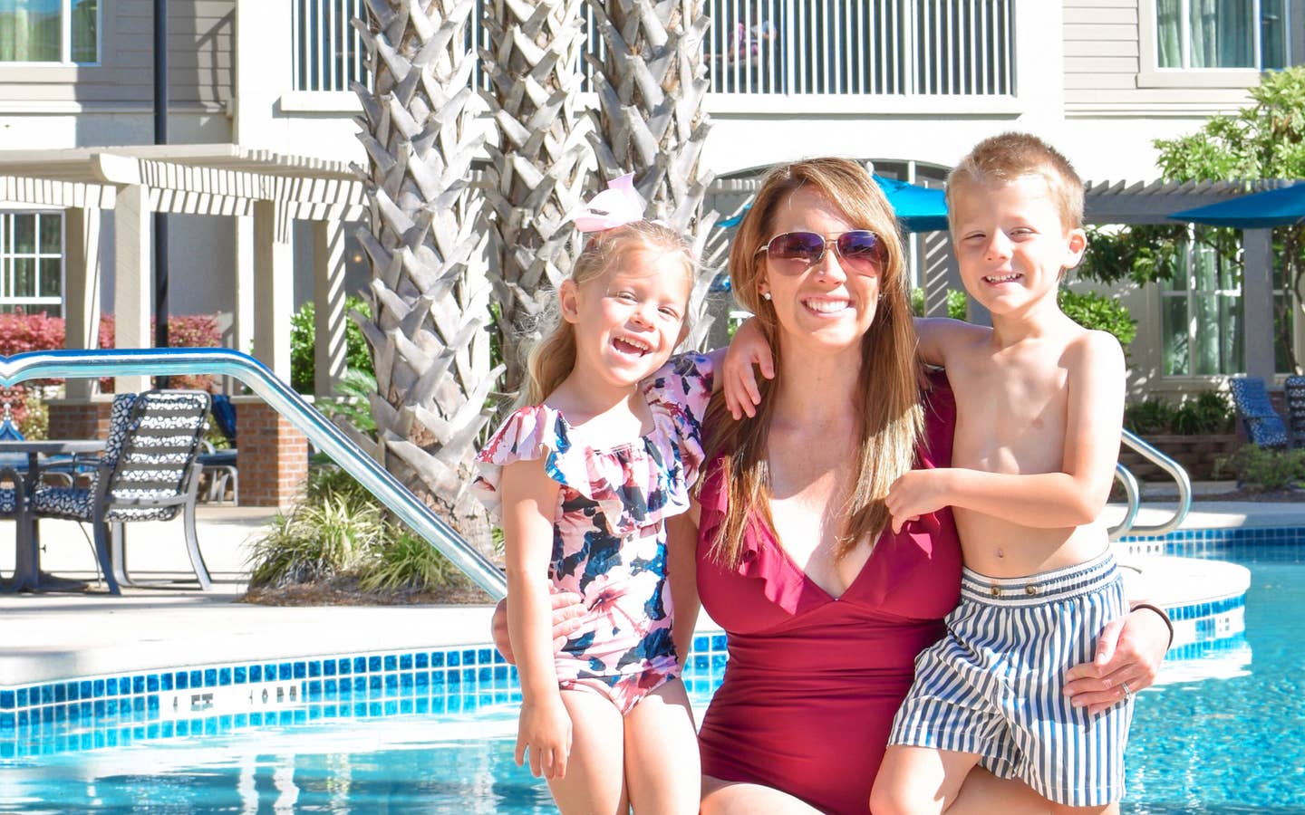 Featured contributor, Brianna Steele (middle), and her two children pose near our pool at South Beach Resort in Myrtle Beach, SC.