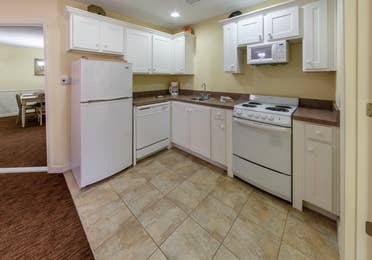 Kitchen with fridge, dishwasher, oven, microwave, and sink in a Presidential two-bedroom villa at Ozark Mountain Resort in Kimberling City, Missouri