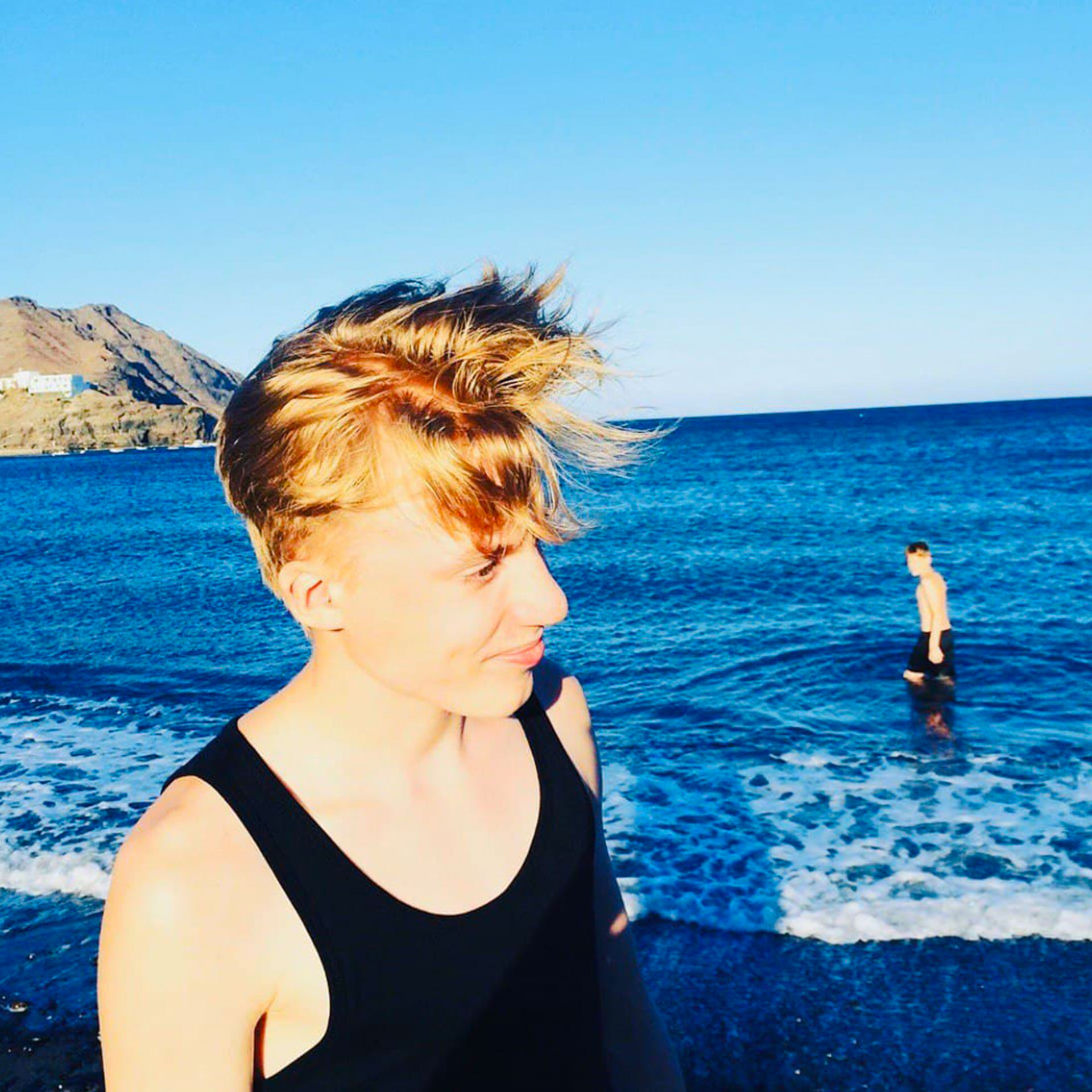 Featured Contributor, Ninka-Bernadette Mauritson's sons walk out on the sands and water of a lake.