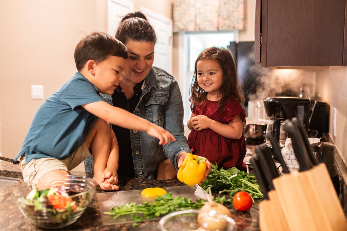 Angelica Kajiwara (middle) prepping fresh produce at our Williamsburg Resort with her son (left) and daughter (right).