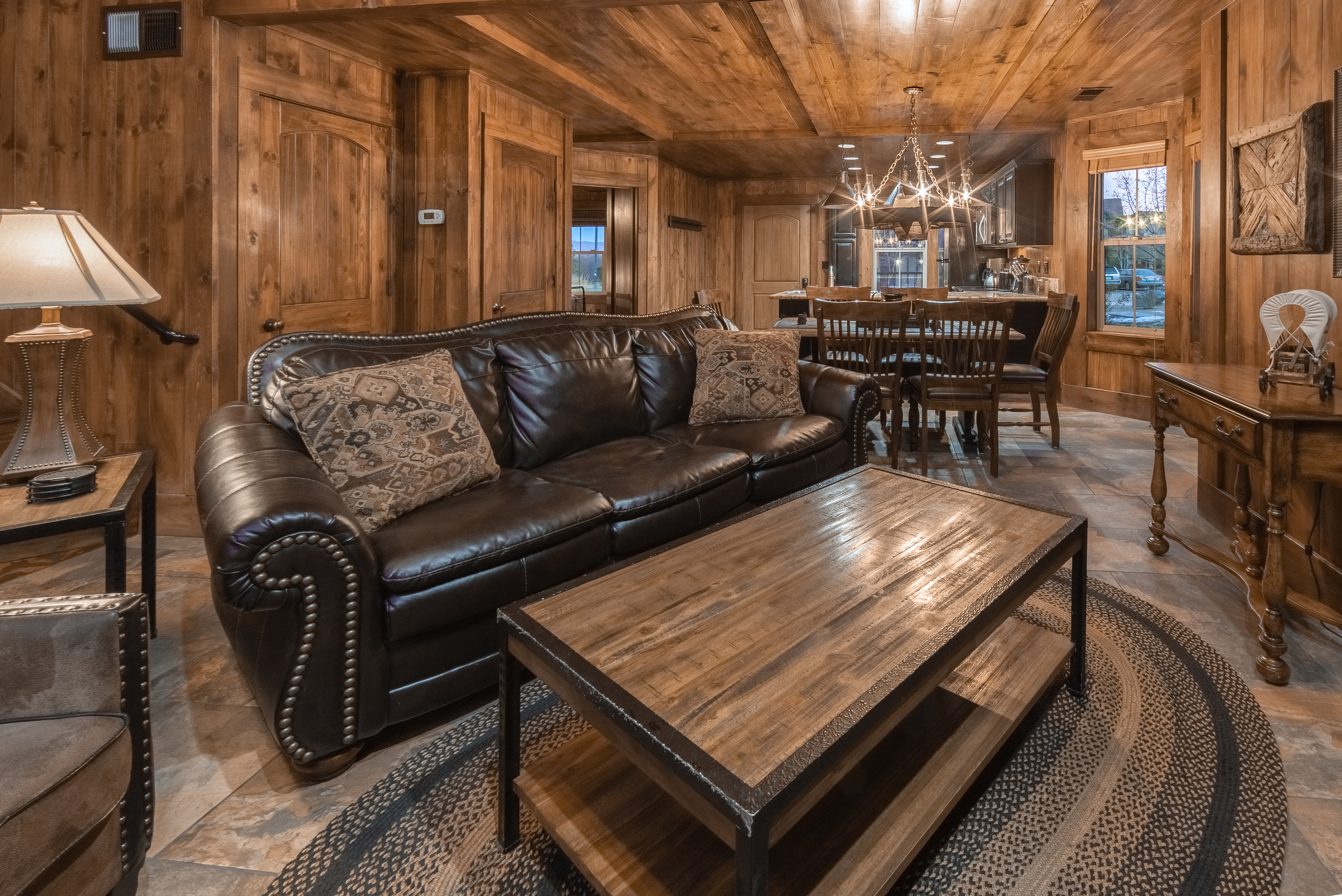 Living room with dining area in background in a deluxe three-bedroom cottage at David Walley's Resort in Genoa, Nevada