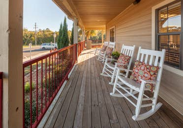Porch with rocking chairs at Piney Shores Resort in Conroe, Texas.