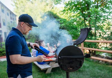 Man barbecuing at Oak n' Spruce Resort in South Lee, Massachusetts.