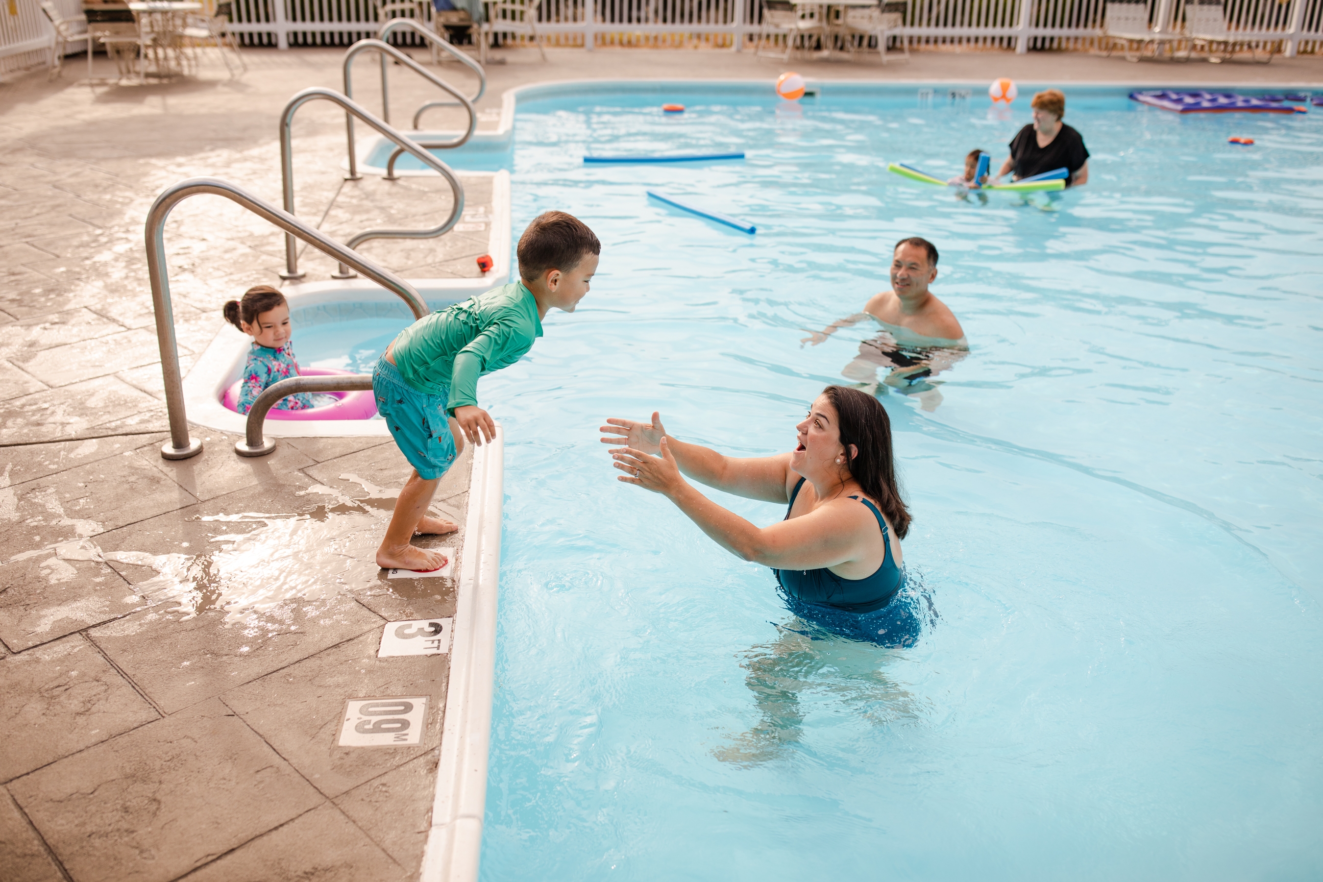 Angelica playing with her son in the pool
