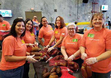 A group of volunteers sorting food at Second Harvest Food Bank in Orlando, FL