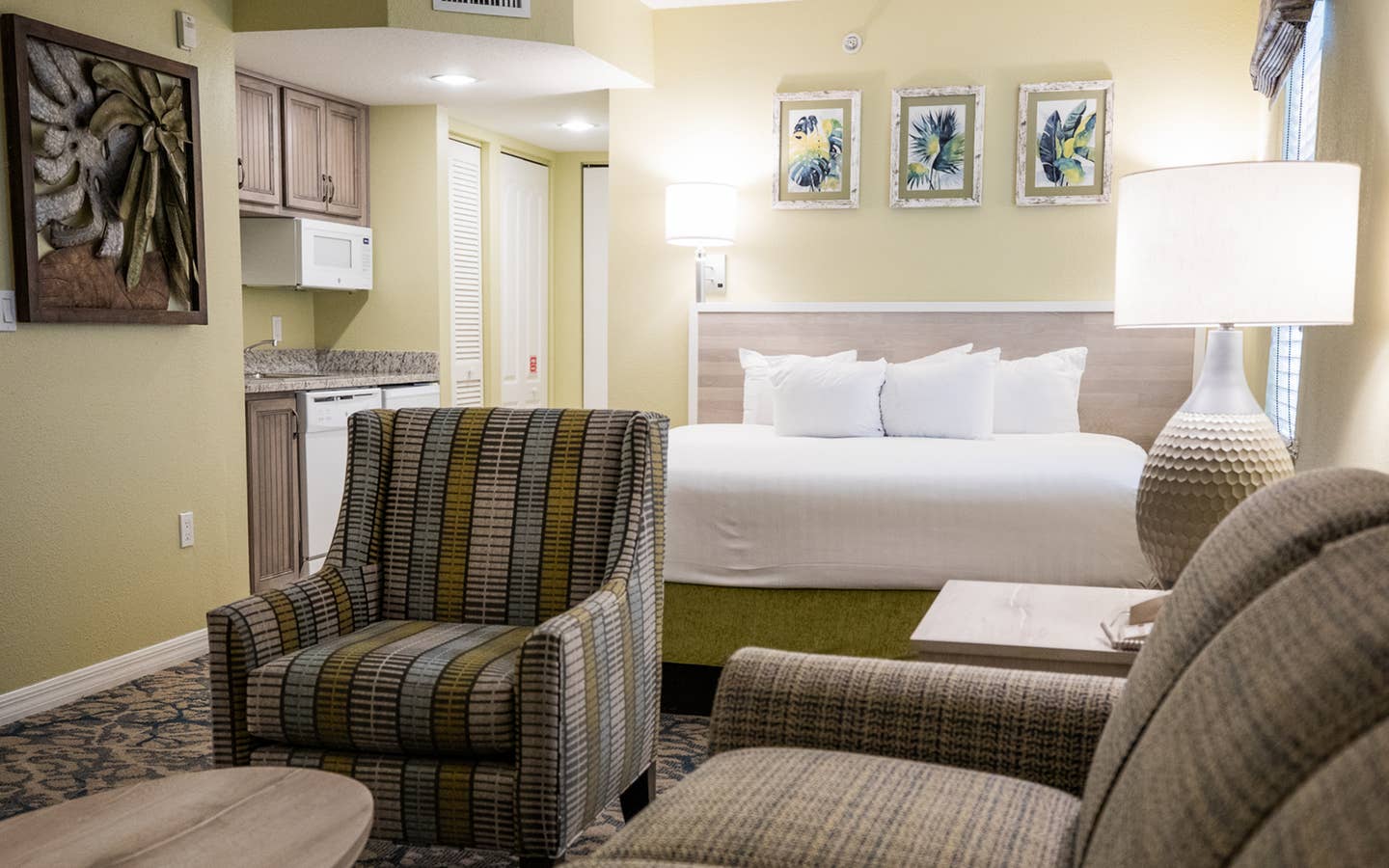 Couch, kitchenette and bed in a villa at Cape Canaveral Resort.