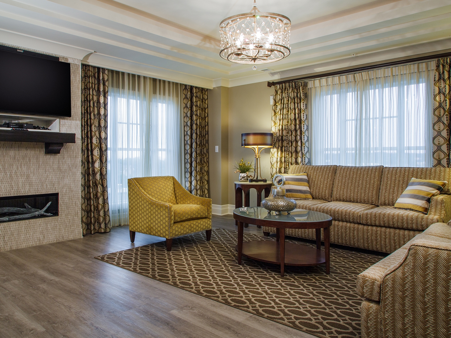 Living room with two couches, a chair and flat screen TV in a three-bedroom Signature Collection villa at South Beach Resort in Myrtle Beach, South Carolina.