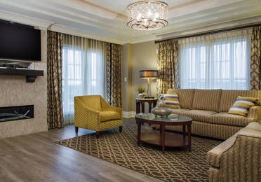 Living room with two couches, a chair and flat screen TV in a three-bedroom Signature Collection villa at South Beach Resort in Myrtle Beach, South Carolina.