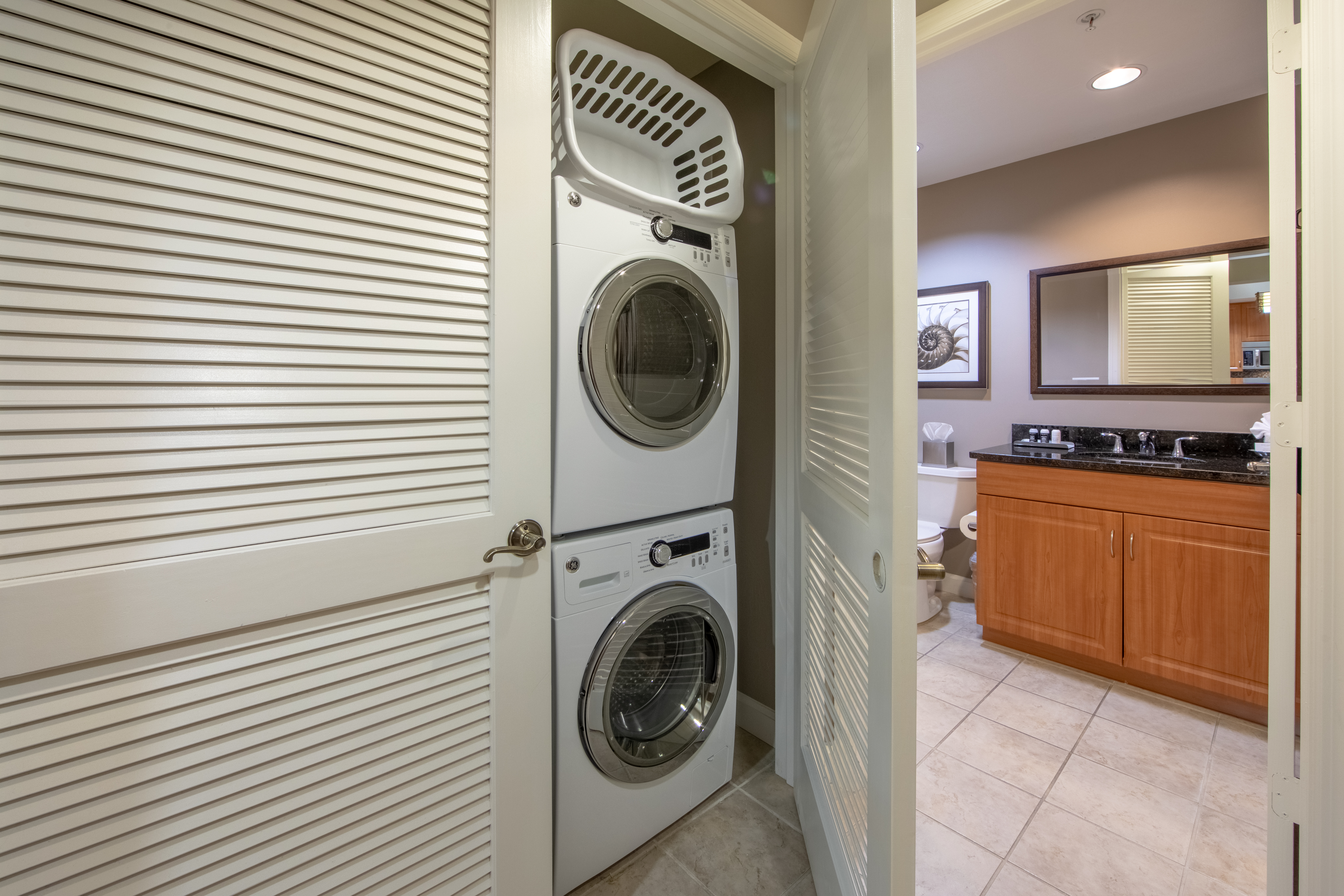 In-unit washer and dryer outside of a bathroom in a three-bedroom villa at Sunset Cove Resort in Marco Island, Florida