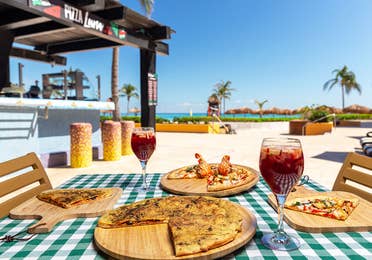The Pizza Luna, Calzone pizza, lobster pizza and 2 glasses of sangria on a beachfront table at the Royal Haciendas, at Playa del Carmen, Mexico