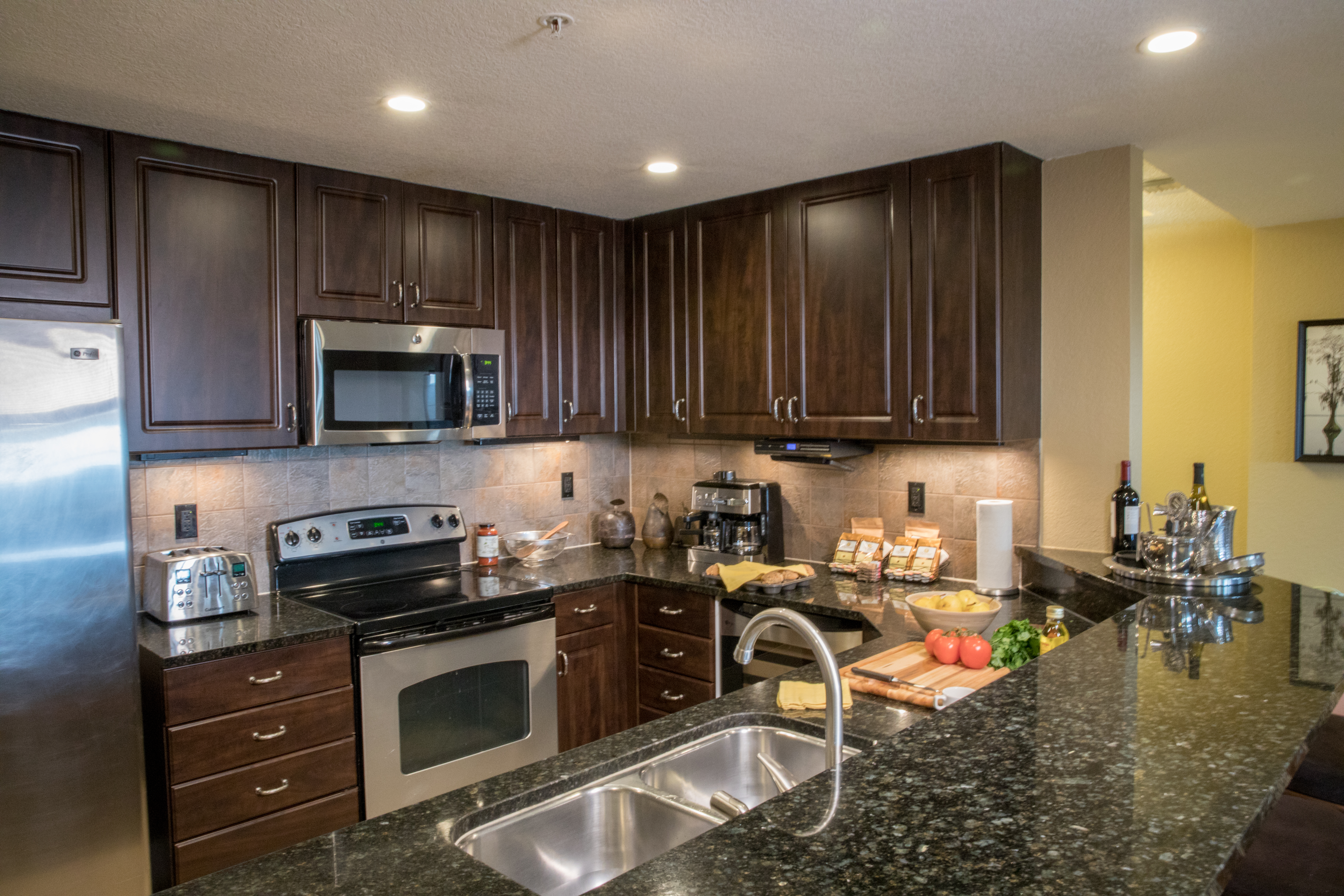 Full kitchen with stainless steel appliances in a four bedroom Signature villa in River Island at Orange Lake Resort near Orlando, Florida
