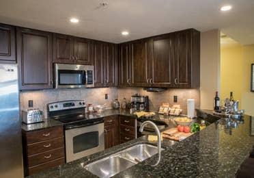 Full kitchen with stainless steel appliances in a four bedroom Signature villa in River Island at Orange Lake Resort near Orlando, Florida