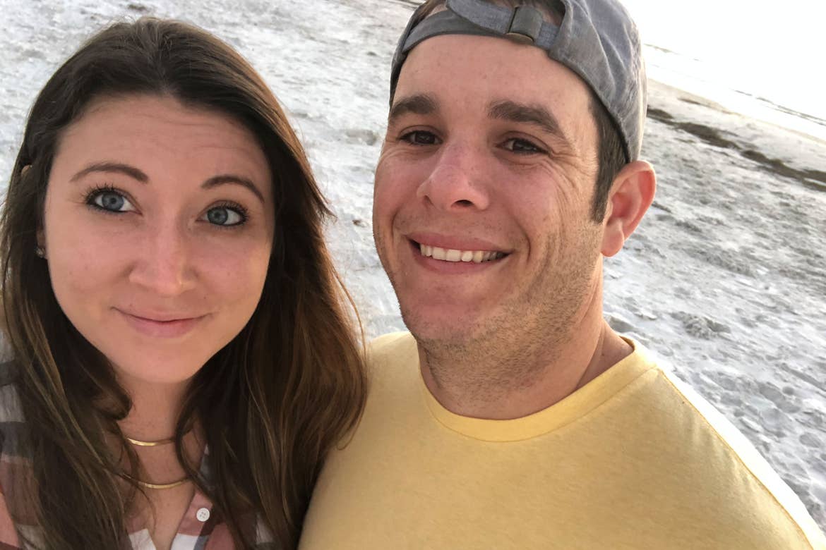 Featured contributor and Checking In editor, Tori Ferrante (left), and her husband, Brooks (right) stand on a beach in Cape Canaveral, Florida.