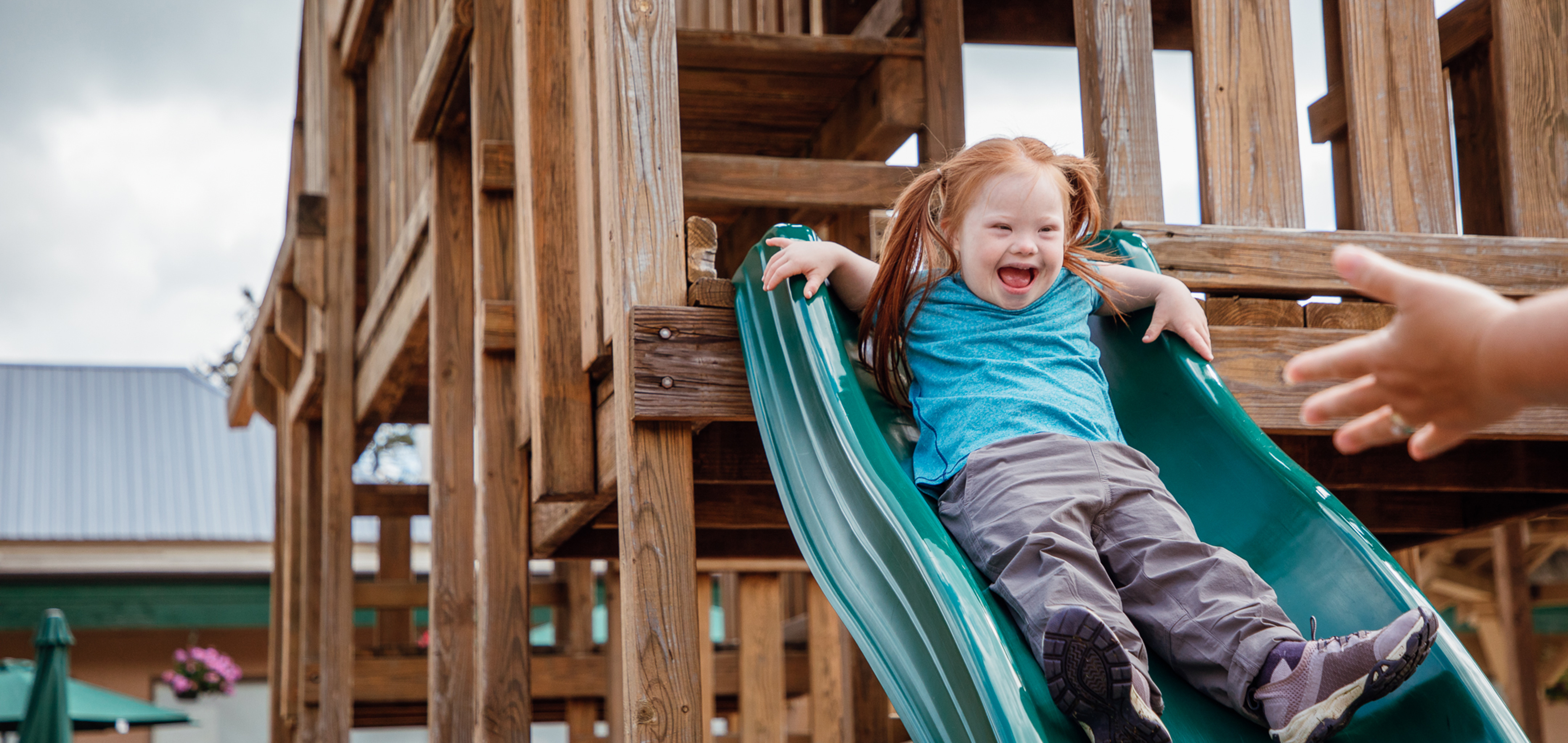 Young girl going down playground slide at Oak n' Spruce Resort in South Lee, Massachusetts.