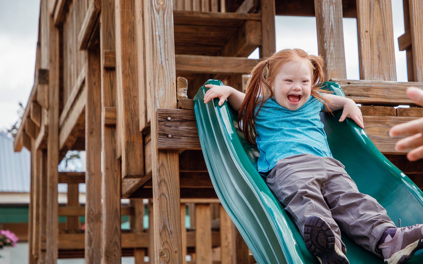 Young girl going down playground slide at Oak n' Spruce Resort in South Lee, Massachusetts.