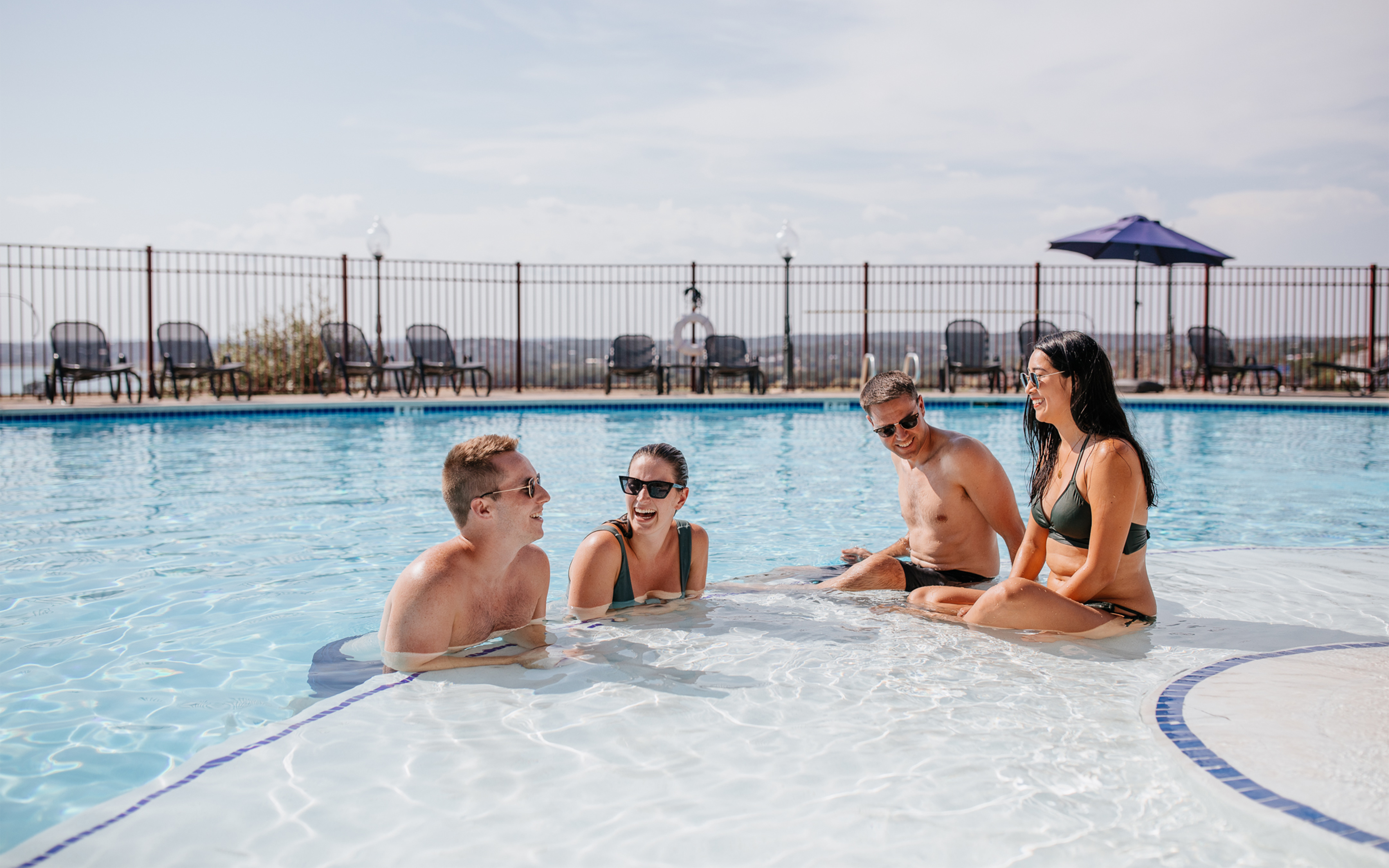 Guests enjoying the outdoor pool at Hill Country Resort in Canyon Lake, Texas
