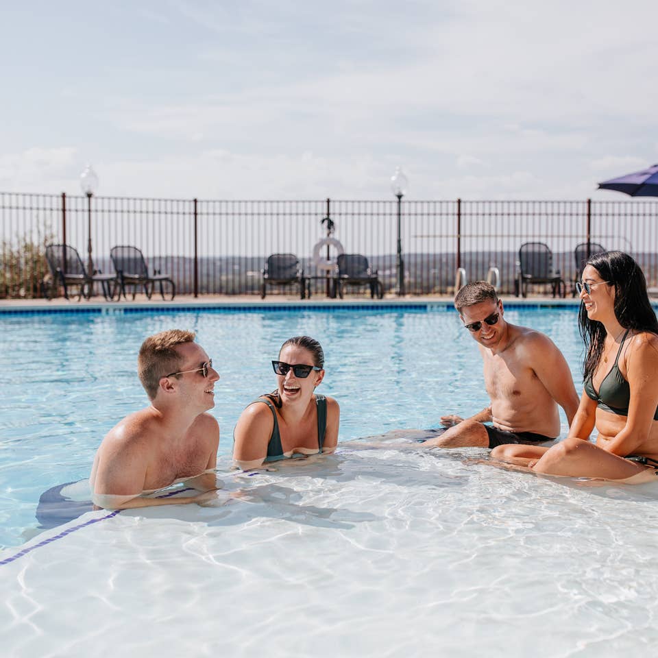 Guests enjoying the outdoor pool at Hill Country Resort in Canyon Lake, Texas