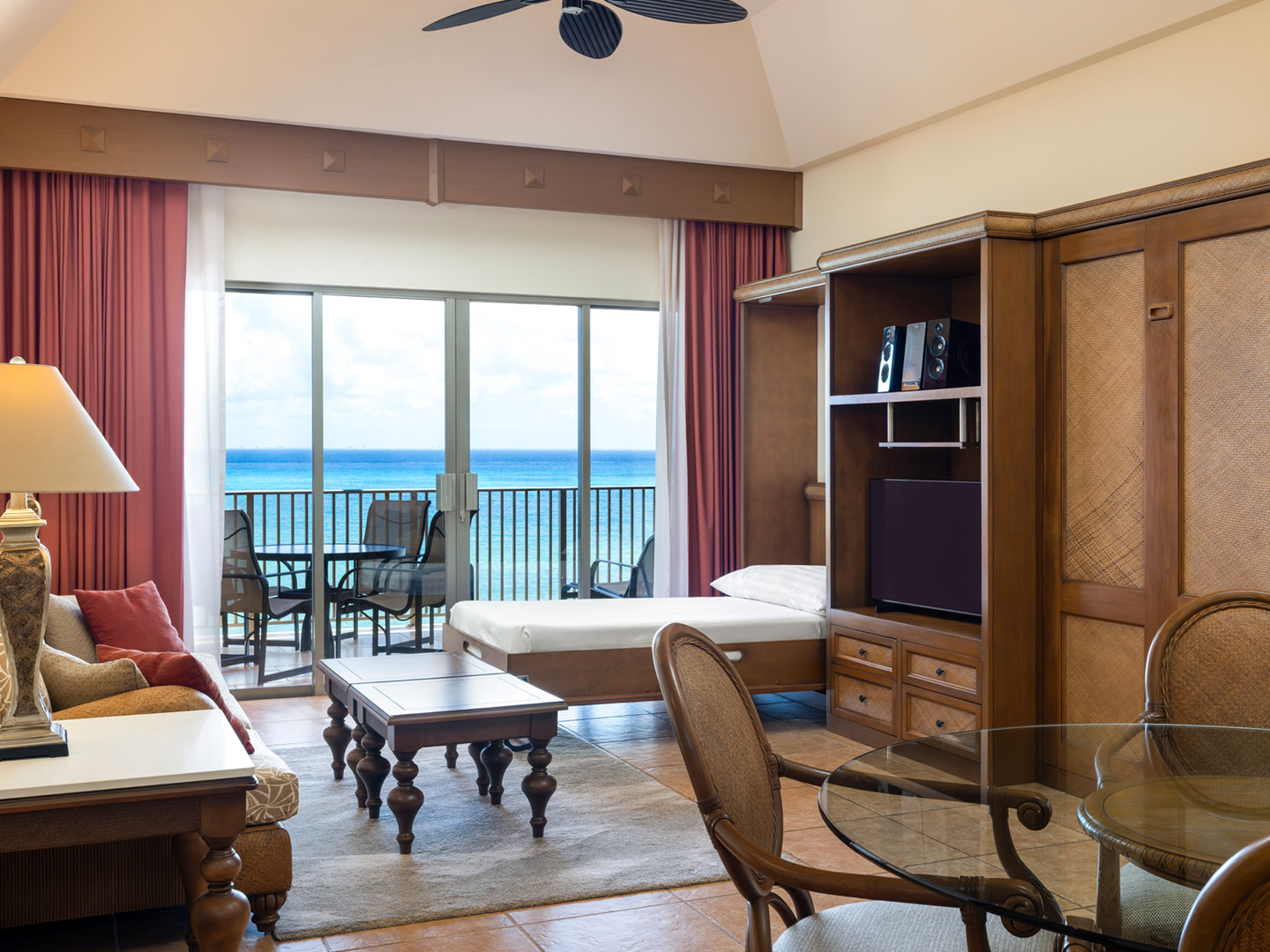 Spacious living room with Murphy bed and balcony access.