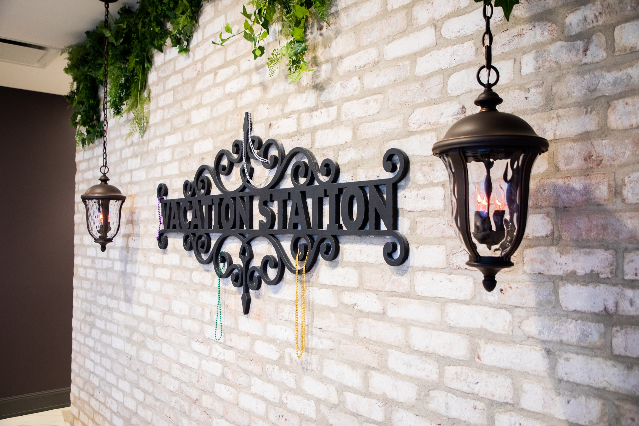 Sign of Vacation Station on light brick wall at New Orleans Resort in Louisiana.