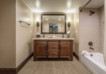Bathroom vanity with large mirror and wall sconces in a Two-Bedroom Signature Collection villa at Scottsdale Resort in Arizona
