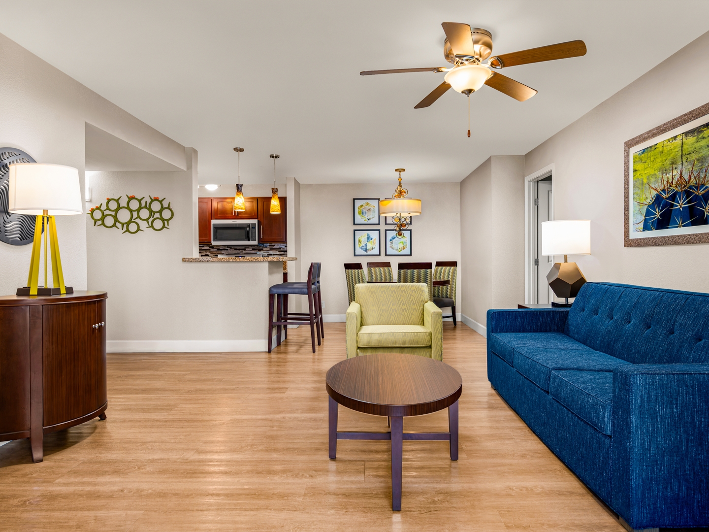 Spacious living area with sofa, dining table, and open kitchen.
