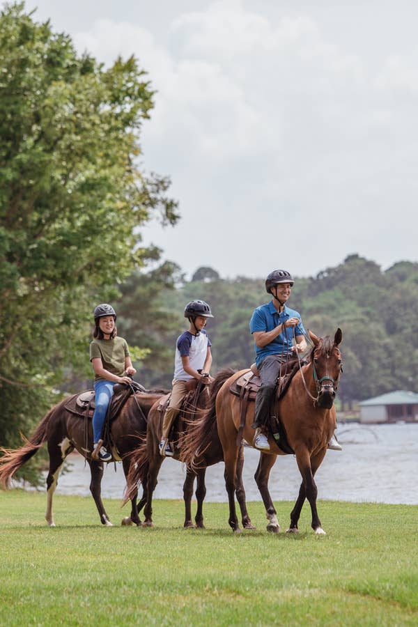 Three guests riding horses at Villages Resort in Flint, Texas.