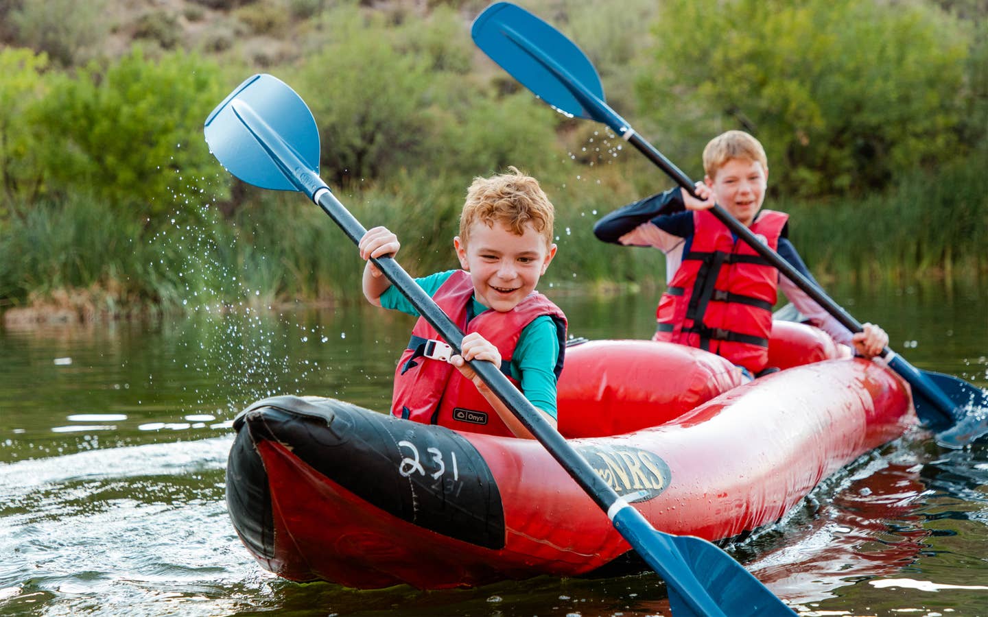Two young children kayaking near Scottsdale Resort.