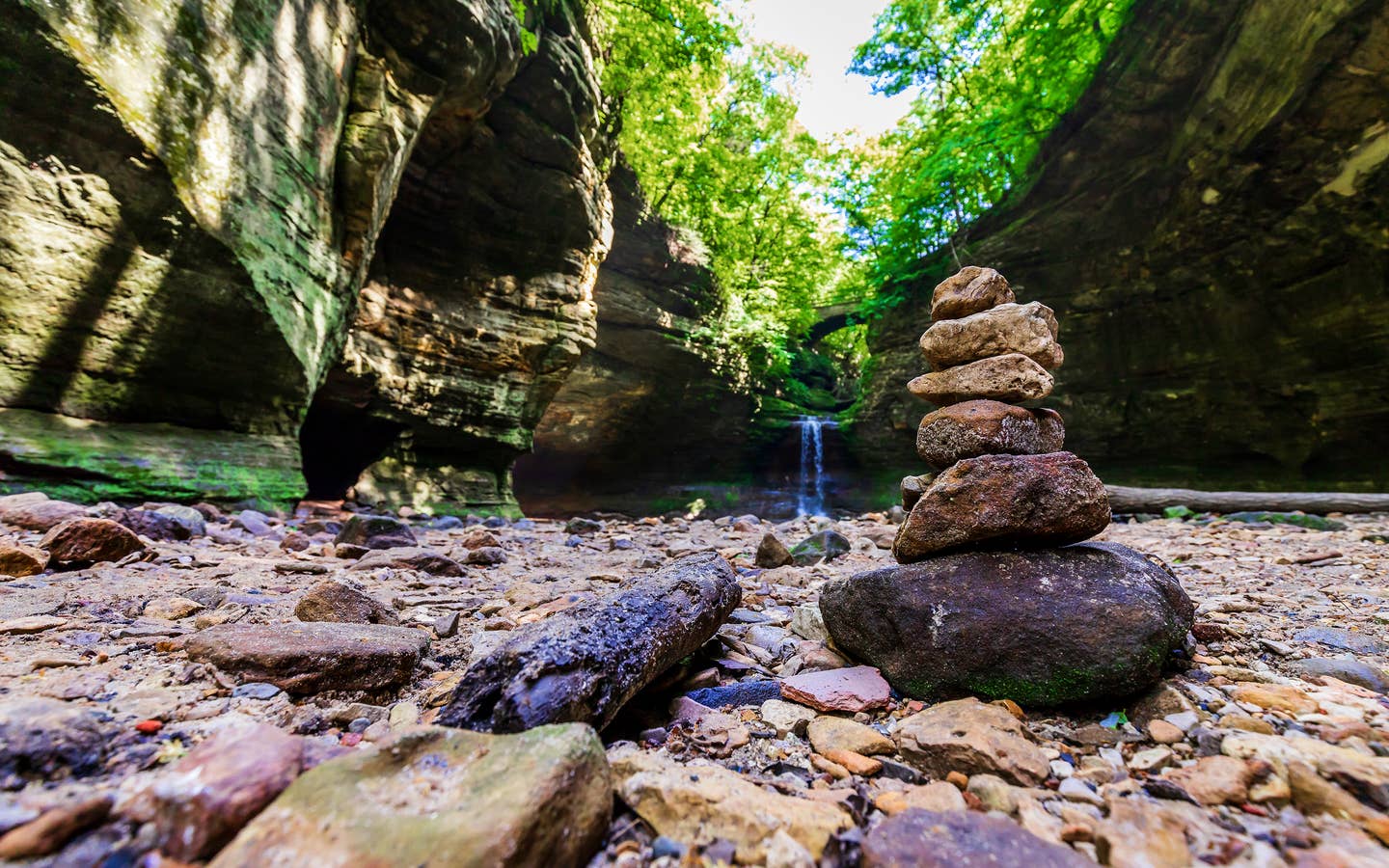Pile of rocks stacked in front of a waterfall at Starved Rock State Park.