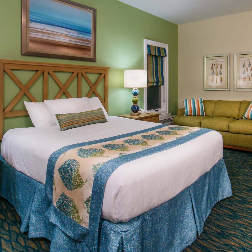 Studio room with a bed, couch and sitting area at South Beach Resort in Myrtle Beach, South Carolina.