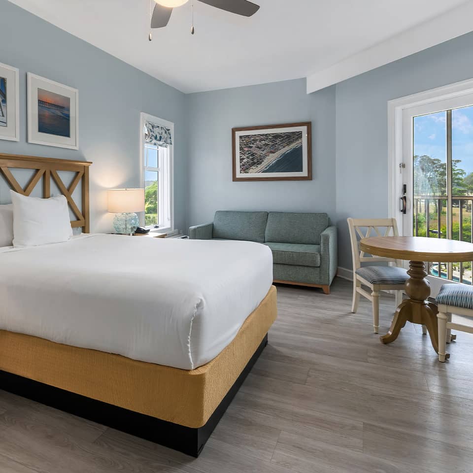 Studio room with a bed, couch and sitting area at South Beach Resort in Myrtle Beach, South Carolina.