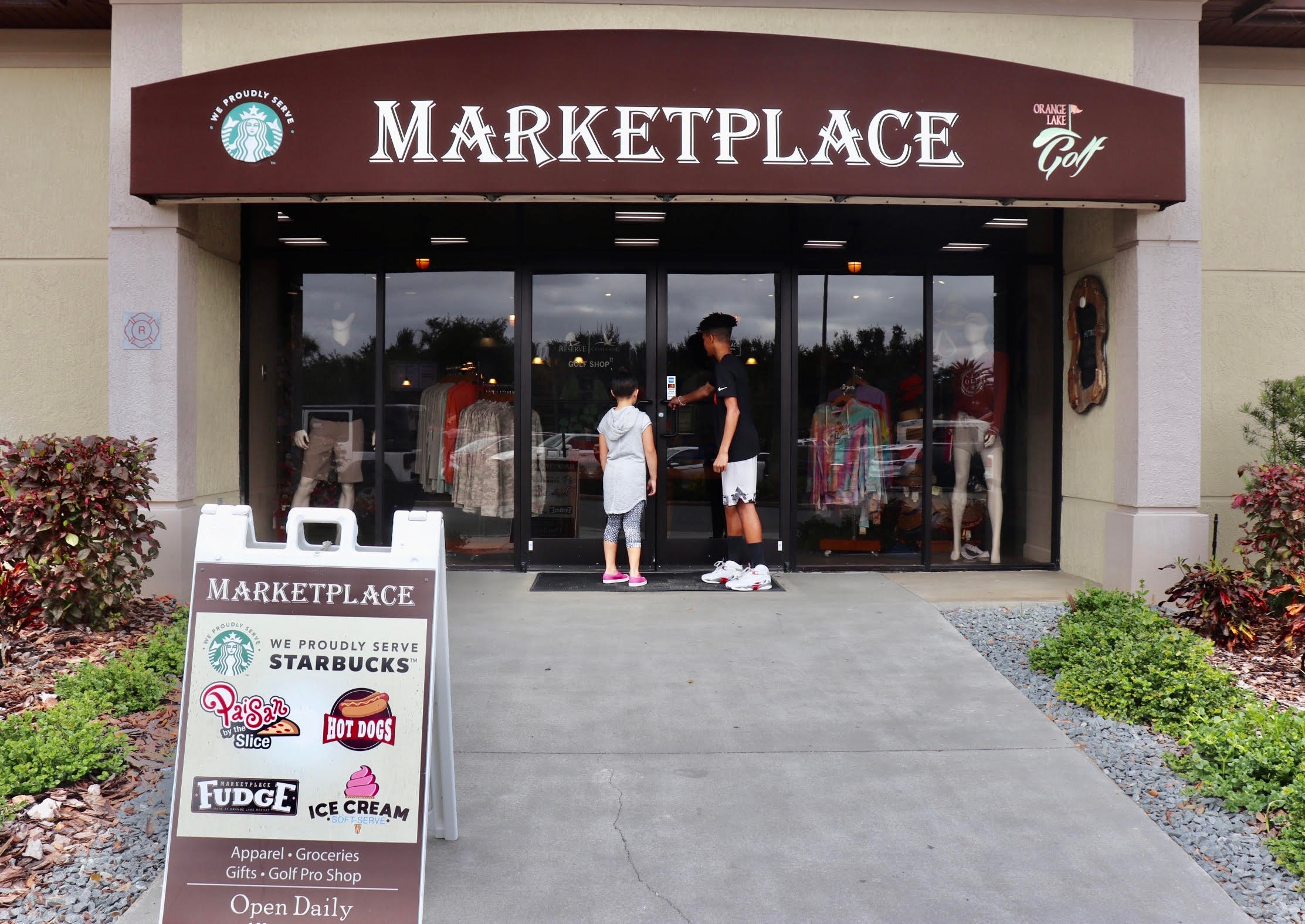 clarissa's kids standing in front of the Marketplace at Orange Lake Resort