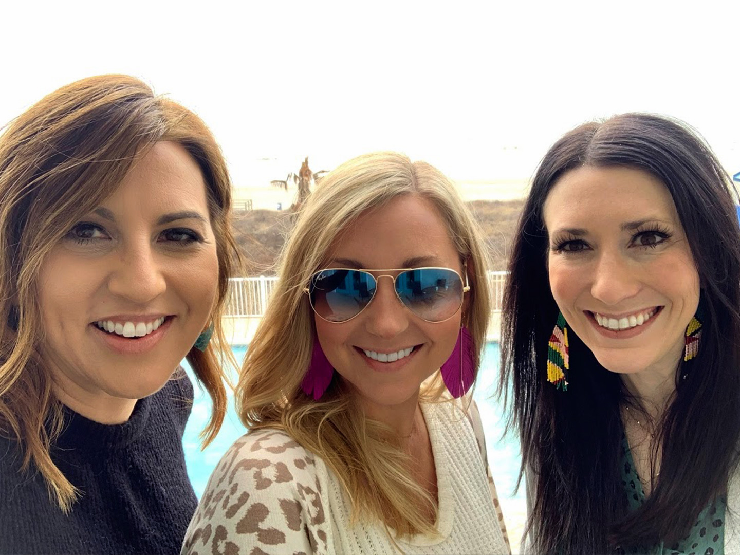 Featured Contributor, Amanda Nall (middle) poses with her two friends on the beach near our Galveston Beach Resort in Galveston, Tx.