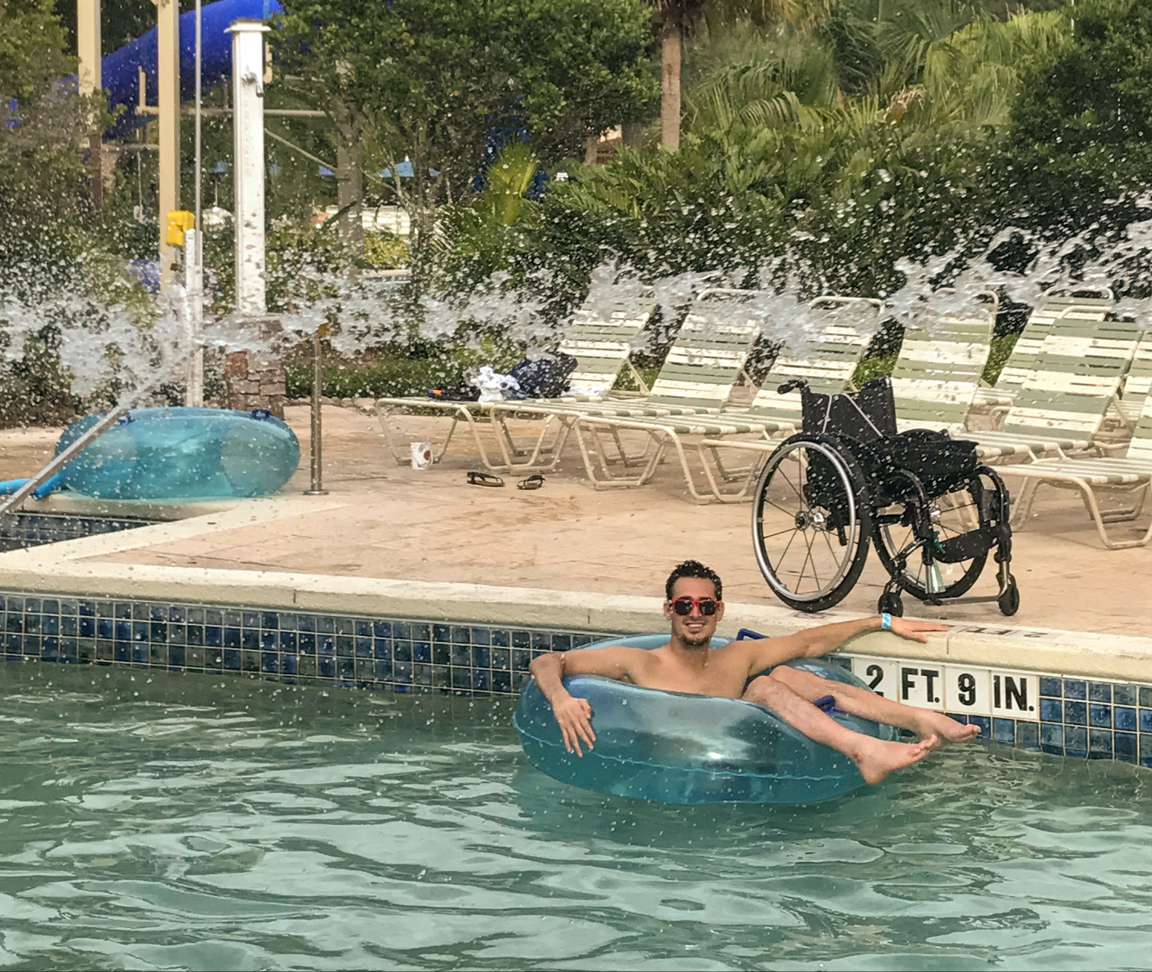 Danny floating in a tube in the pool at Orange Lake Resort