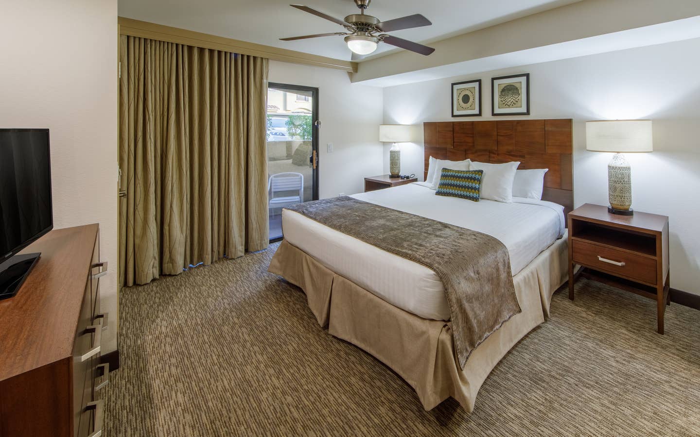 Master bedroom with access to balcony in a one-bedroom villa at Scottsdale Resort