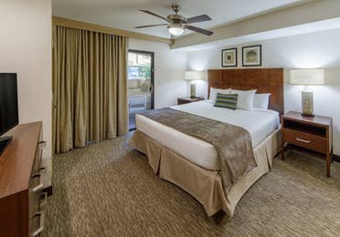 Master bedroom with access to balcony in a one-bedroom villa at Scottsdale Resort
