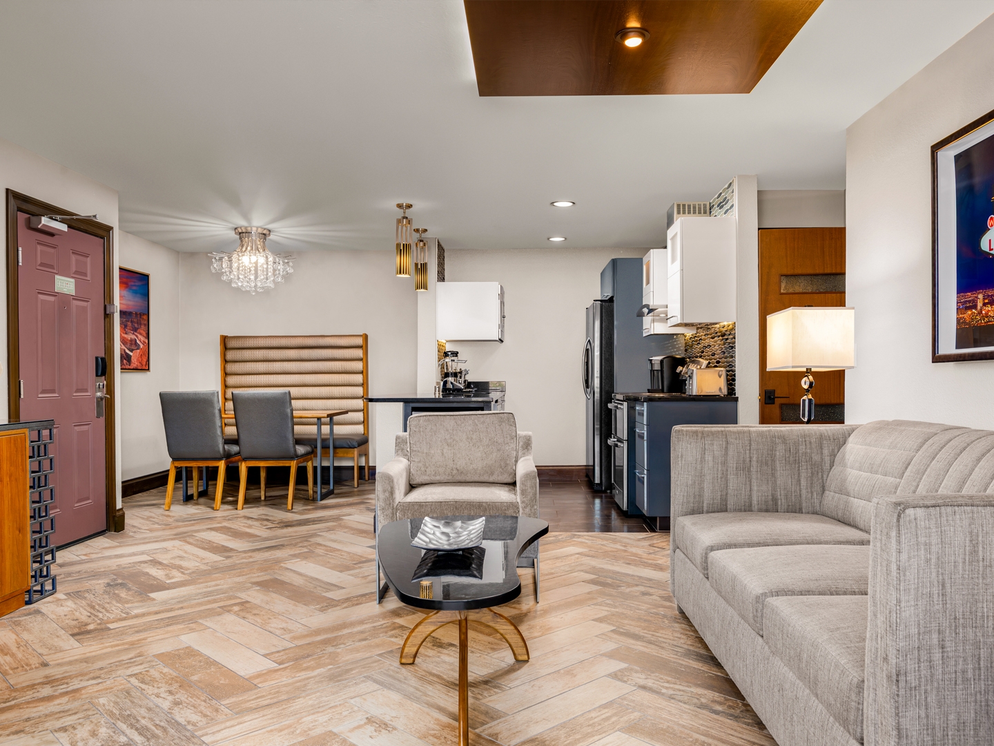 Modern suite with chic decor, full kitchen, and stylish seating area.

