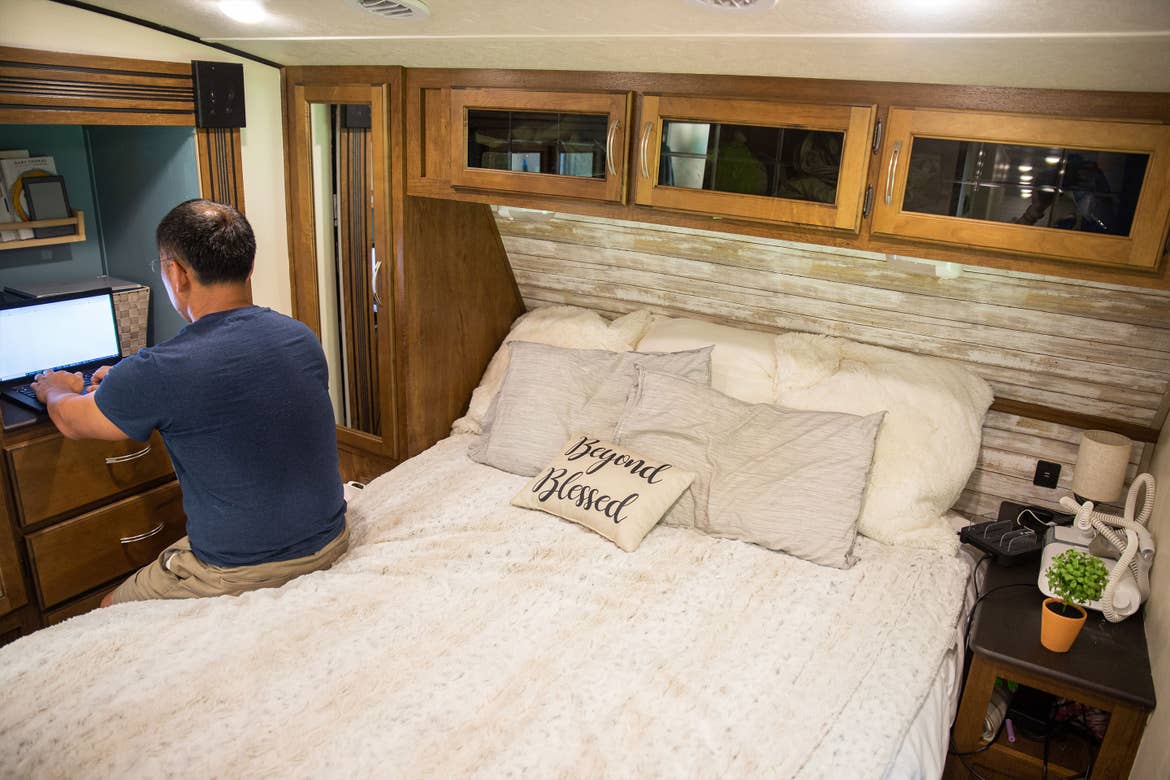 Jaques (left) sits in the RV Master Suite working remotely.
