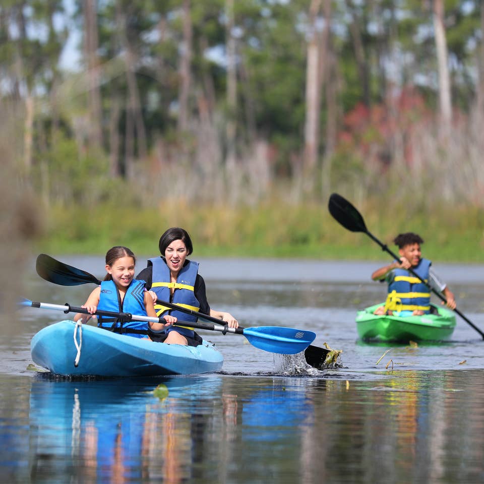 Three visitors kayaking at Villages Resort in Flint, Texas.
