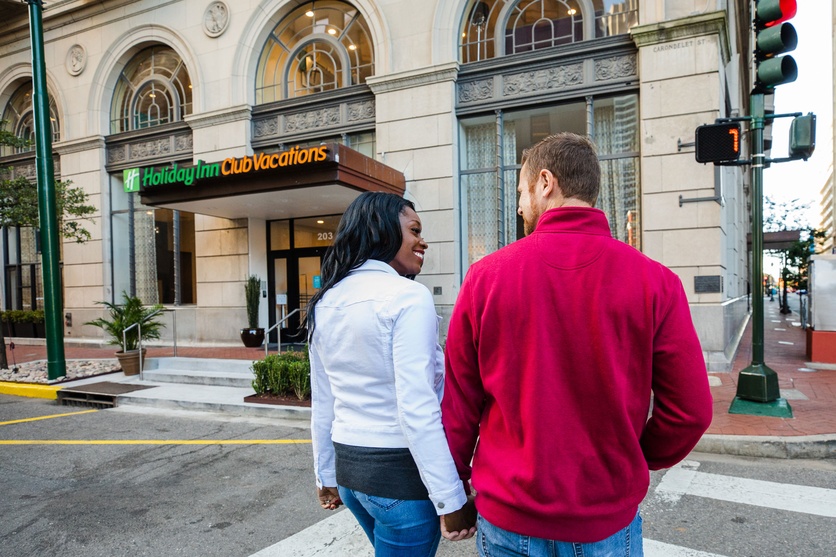 Featured Contributor, Sally Butan (left) of @butanclan walks with her husband, Kevin (right), towards the entrance of our resort exterior in New Orleans, Louisiana.