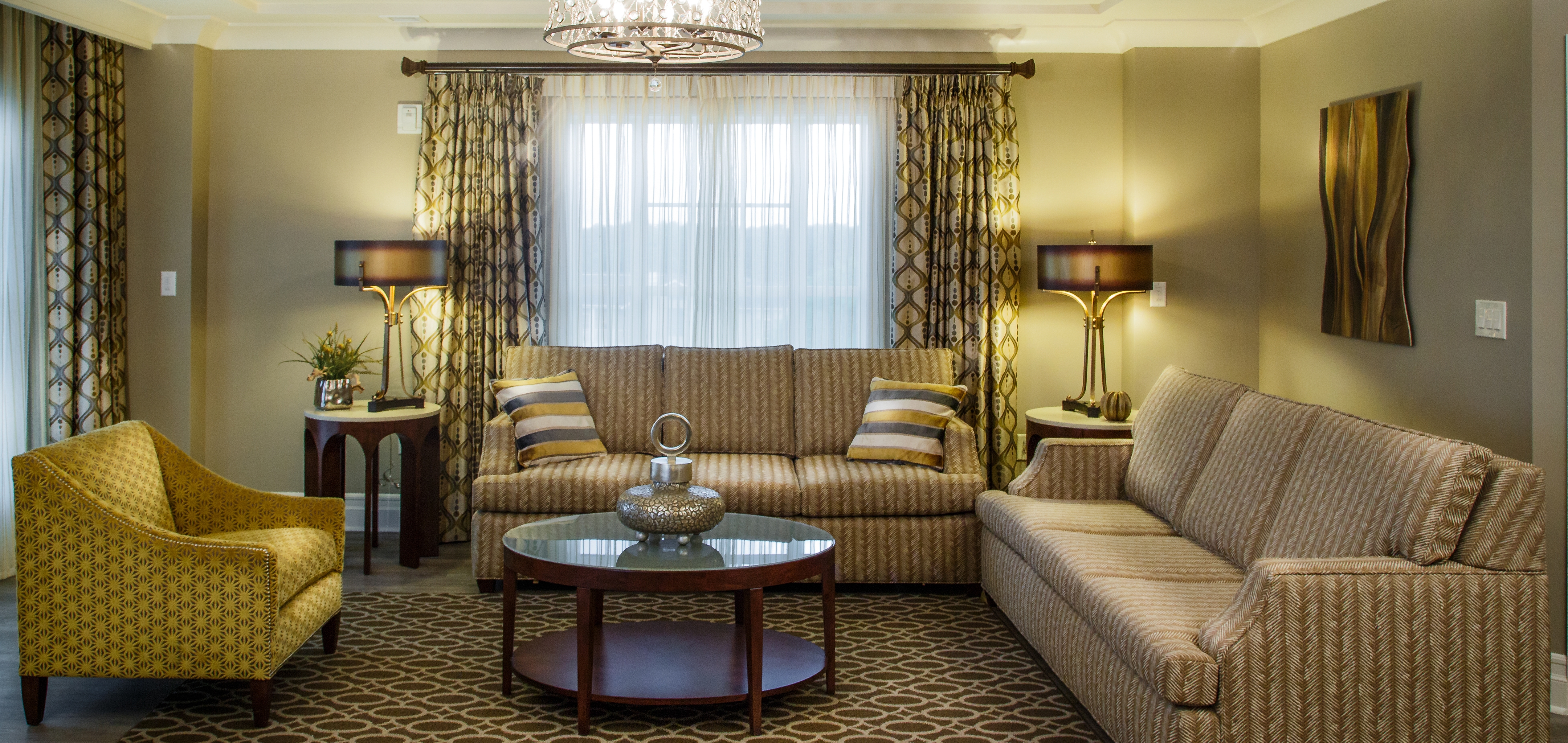 Living room with two couches and a chair in a three-bedroom Signature Collection villa at South Beach Resort in Myrtle Beach, South Carolina.